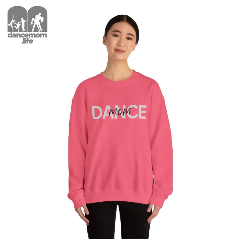 Pink crewneck sweatshirt with ’DANCE’ text printed on the front.