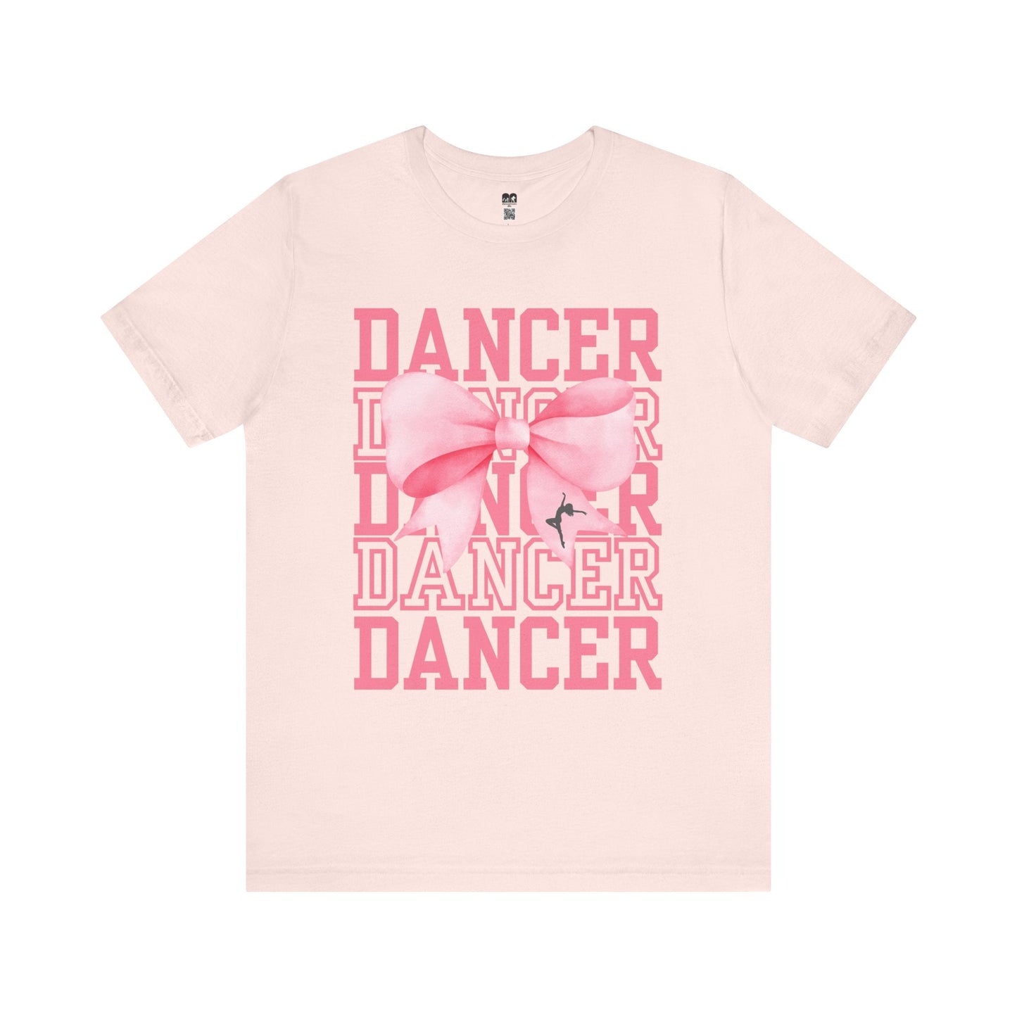 A soft pink cotton t-shirt featuring a bold graphic with the word ’dancer’ repeated in stacked rows and adorned with a large, illustrated bow.