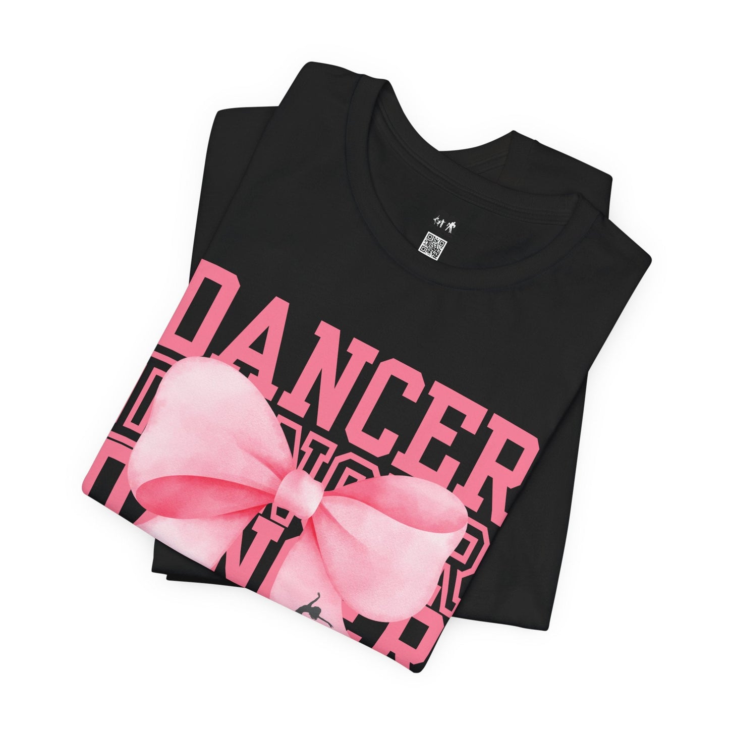 Black cotton t-shirt featuring bold pink ’dancer’ lettering and a large, glossy pink bow graphic.