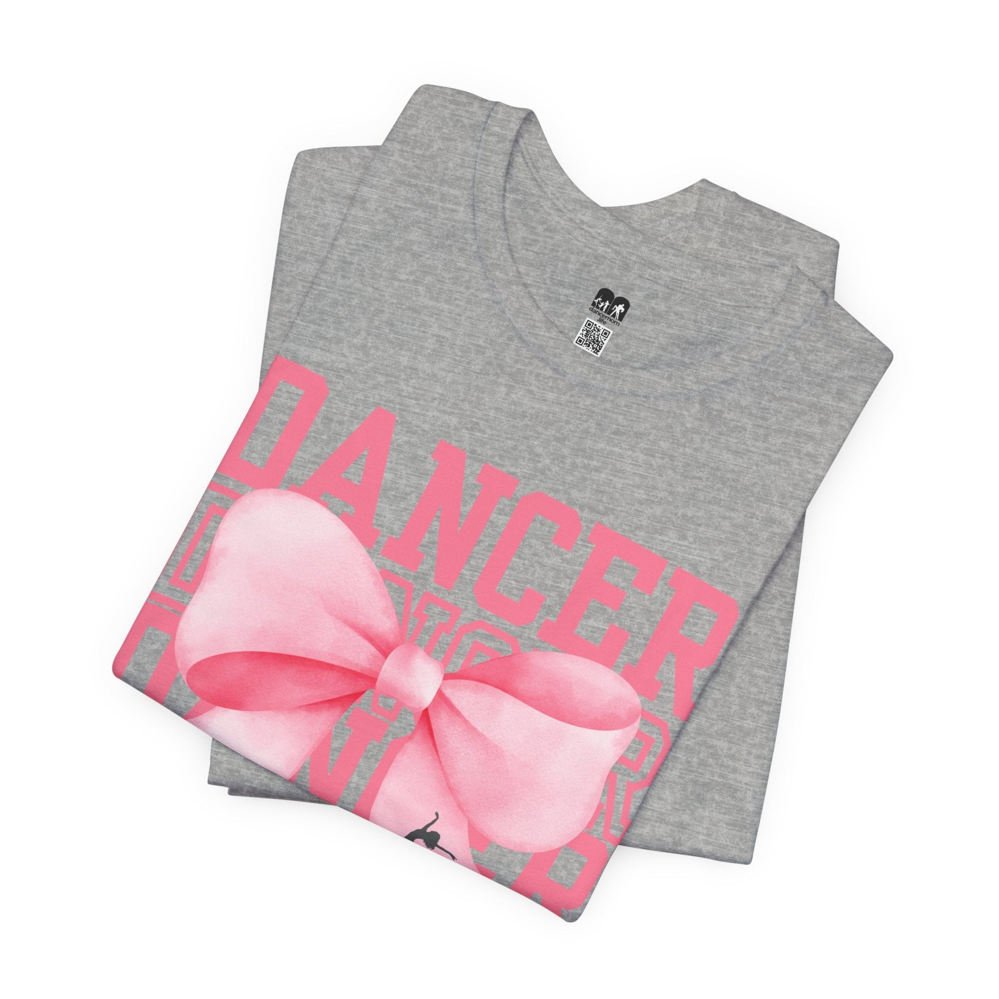 Gray heathered cotton t-shirt featuring bold pink ’dancer’ lettering and a large watercolor-style pink bow graphic.