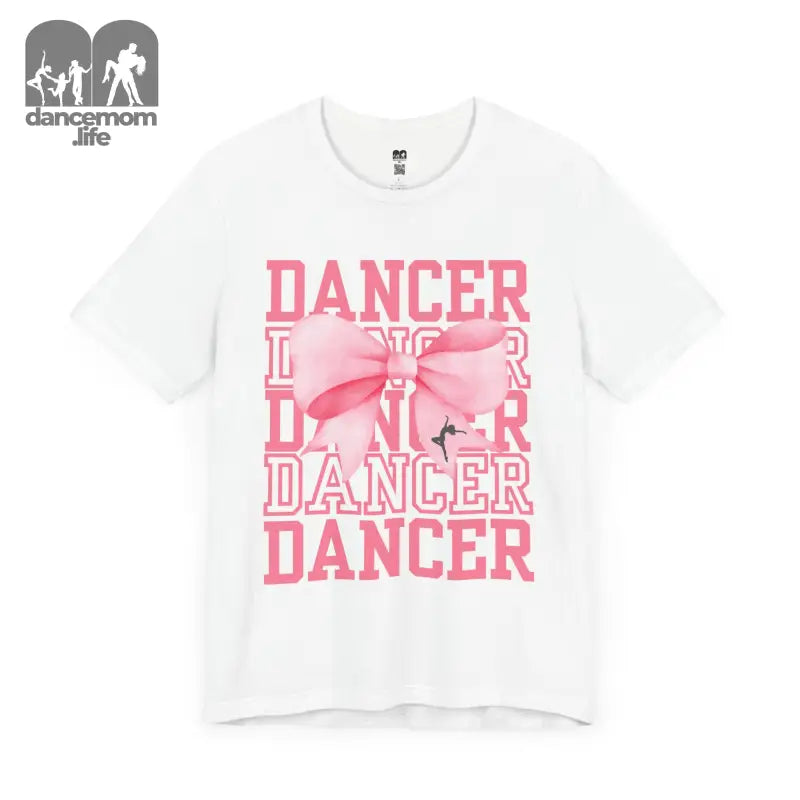 White t-shirt with pink ’DANCER’ text and bow design printed on the front.