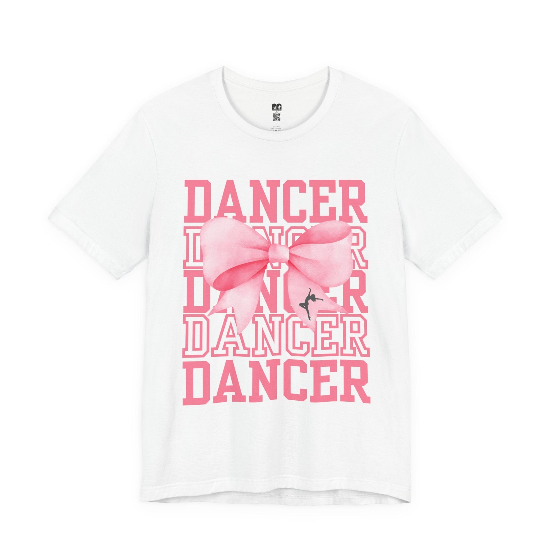 White cotton t-shirt featuring a bold pink ’dancer’ graphic with layered text and a large, stylized bow centered over the words.
