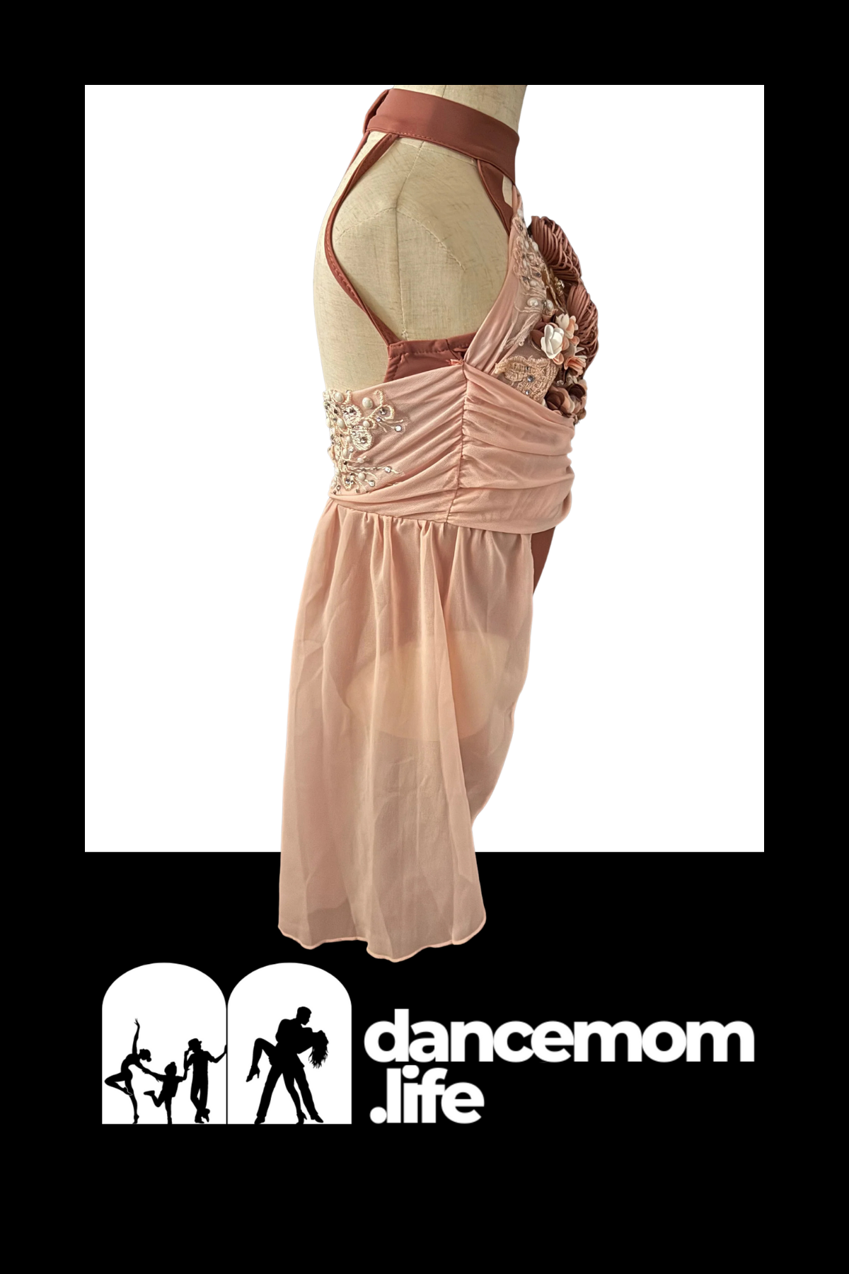 A blush pink satin dance leotard with lace and floral embellishments.