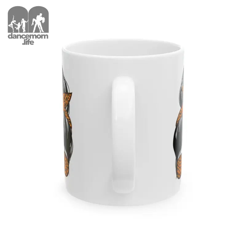 White ceramic coffee mug with a cat design on the side.