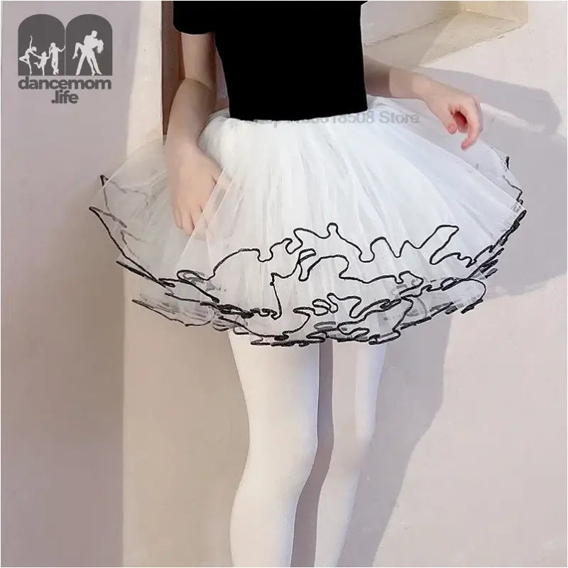 White tutu skirt with black trim along the edges.