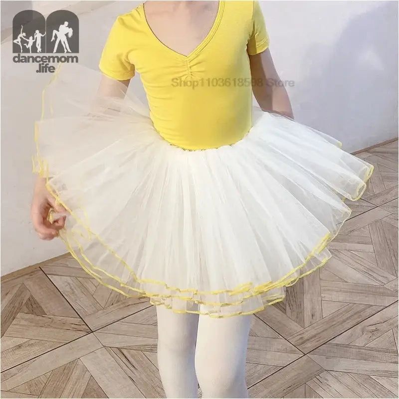 White tulle ballet tutu with yellow trim and matching yellow leotard.