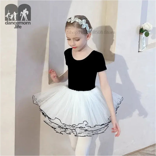 Classic ballet outfit with black leotard and white tutu skirt.