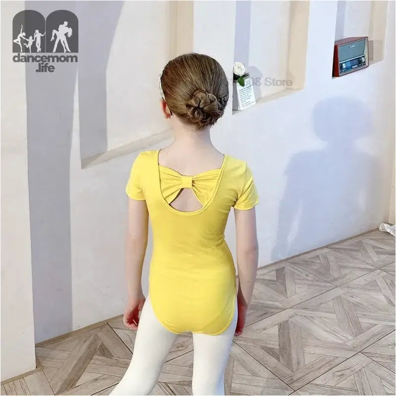 Yellow t-shirt with a bow cutout detail on the back.