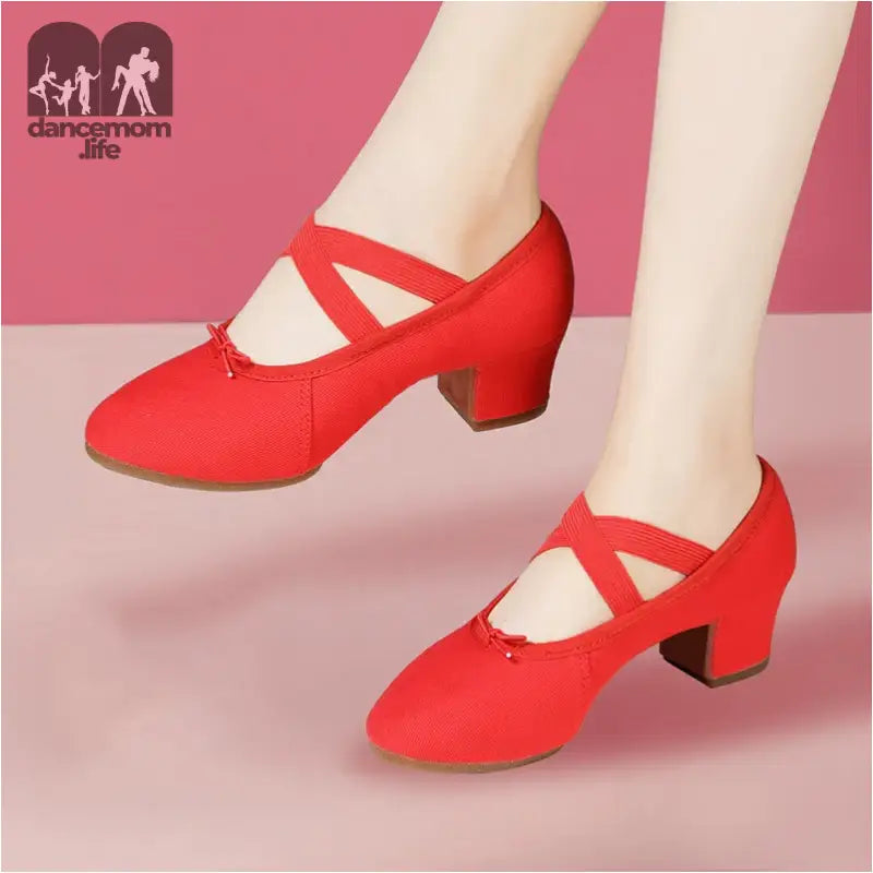 Red dance shoes with criss-cross straps.