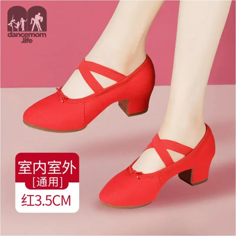 Red canvas dance shoes with criss-cross straps.