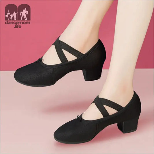 Black dance shoes with criss-cross straps.