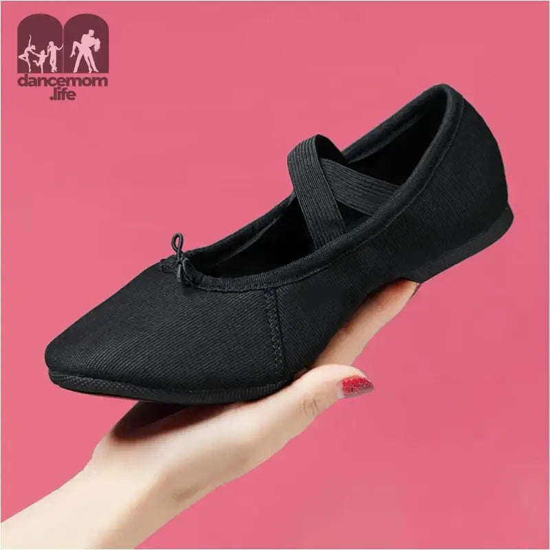 Black canvas ballet shoe.