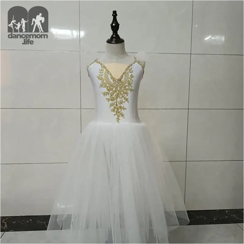 White tulle dress with gold embroidered bodice on a mannequin.