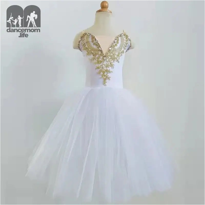 White tulle dress with gold sequined bodice detailing.