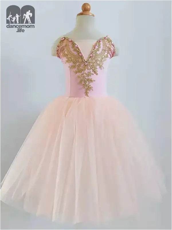 Pink tulle dress with gold sequined bodice and cap sleeves.