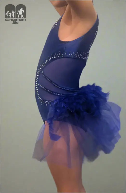 Blue figure skating dress with rhinestone accents and a tulle skirt.