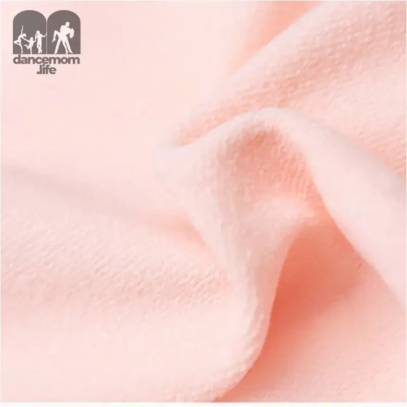 Soft pink fabric with gentle folds and creases.