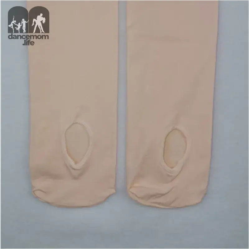 Pair of beige ballet tights with holes at the toes.