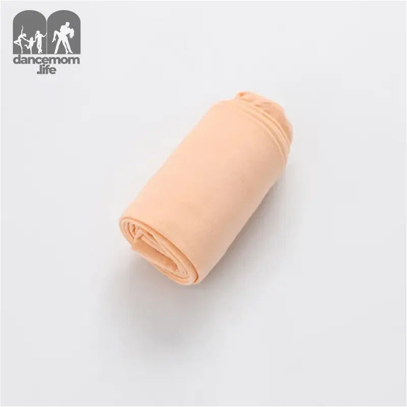 Rolled-up peach-colored fabric or textile material.