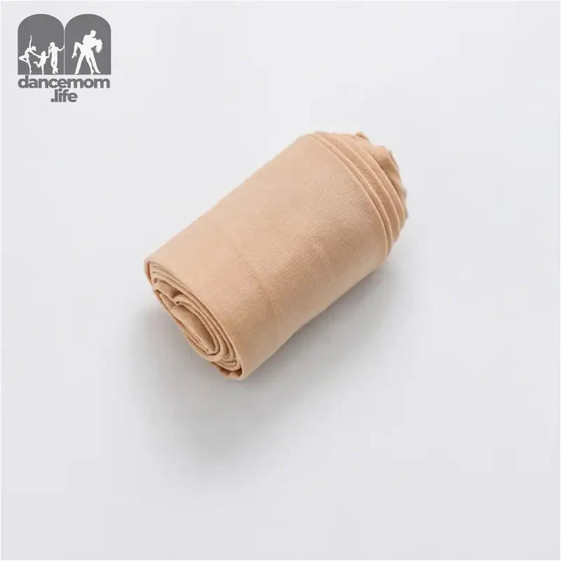 Rolled up beige fabric or cloth.