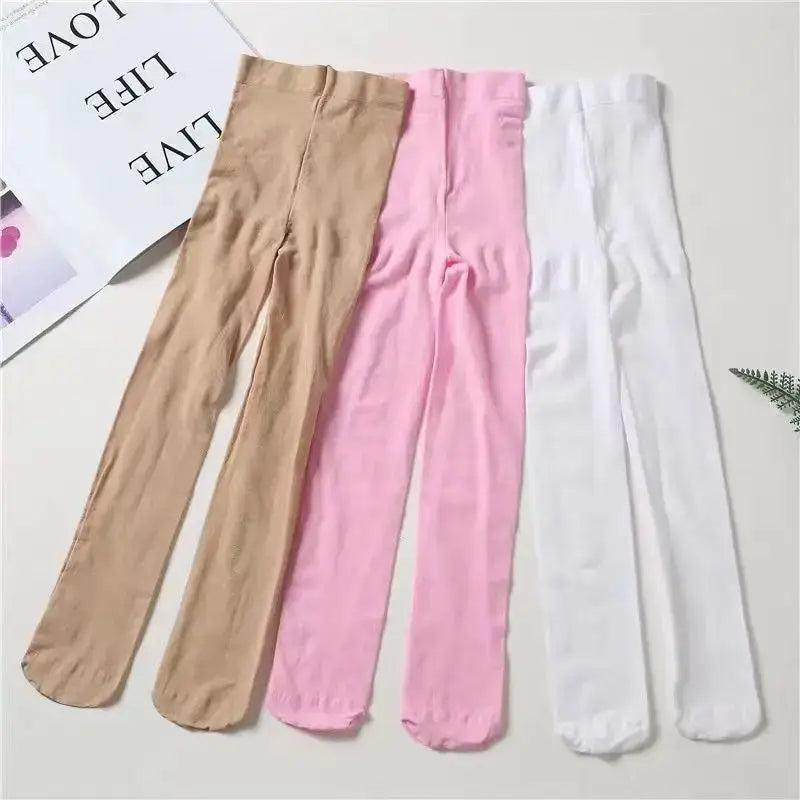Three pairs of ballet tights in beige, pink, and white colors.