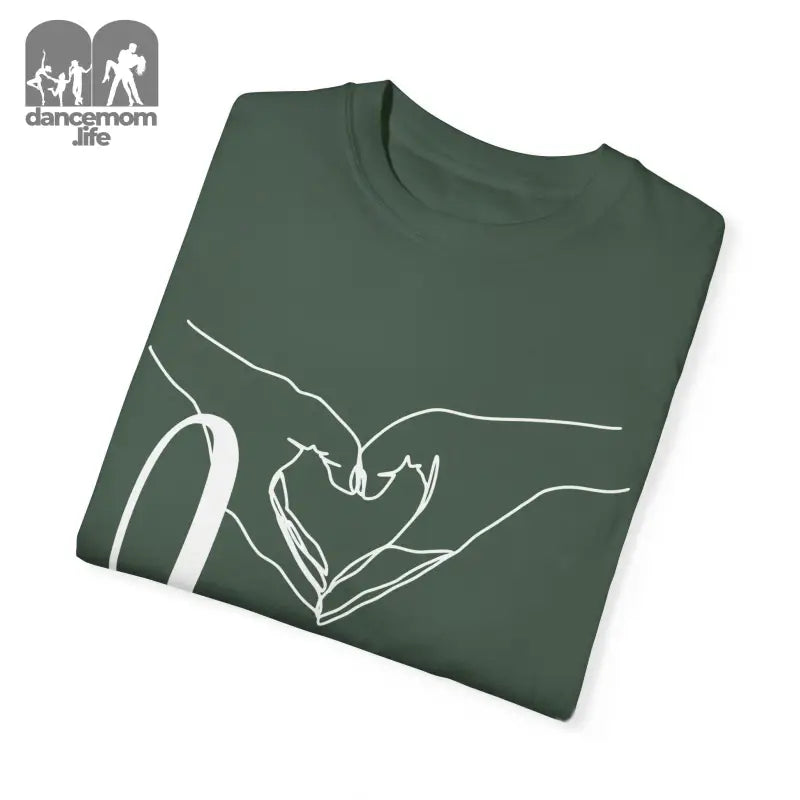 Folded green t-shirt with white hand-drawn heart design.