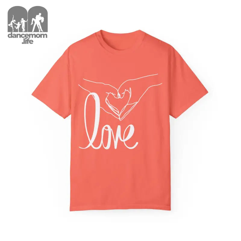 Coral-colored t-shirt with white hands forming a heart shape and ’love’ text design.