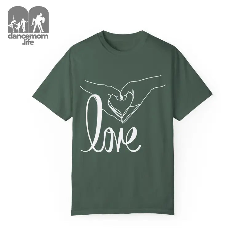 Green t-shirt with white hand-drawn heart gesture and ’love’ text design.