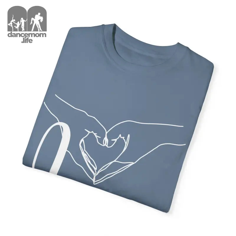 Folded blue-gray t-shirt with a white hand-drawn heart design.