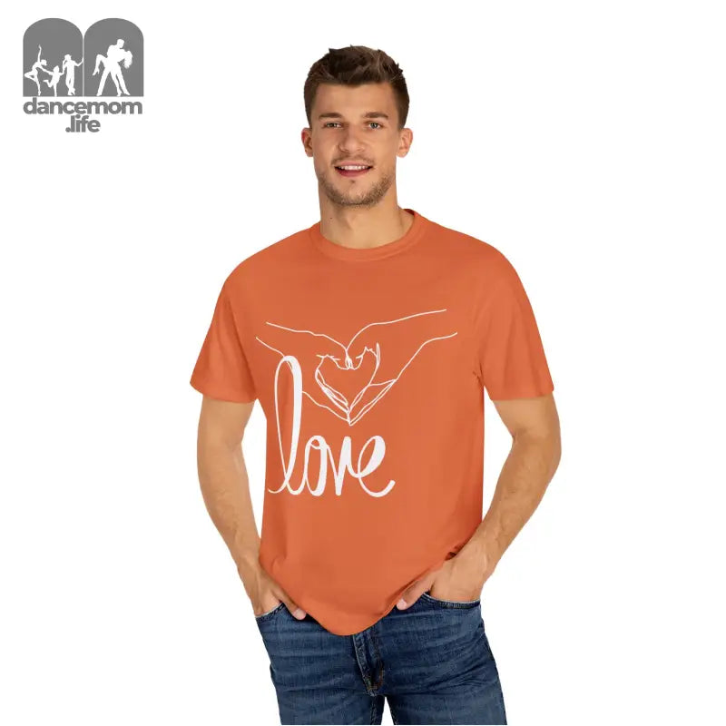 Orange t-shirt with white ’love’ text and hand design on the front.