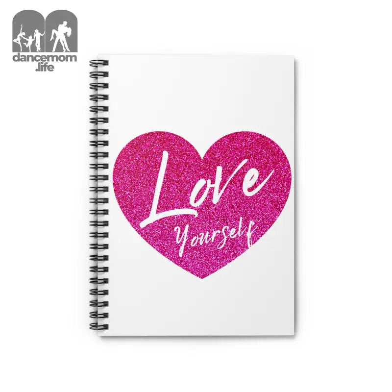 Spiral notebook with a pink glittery heart containing ’Love Yourself’ text on the cover.