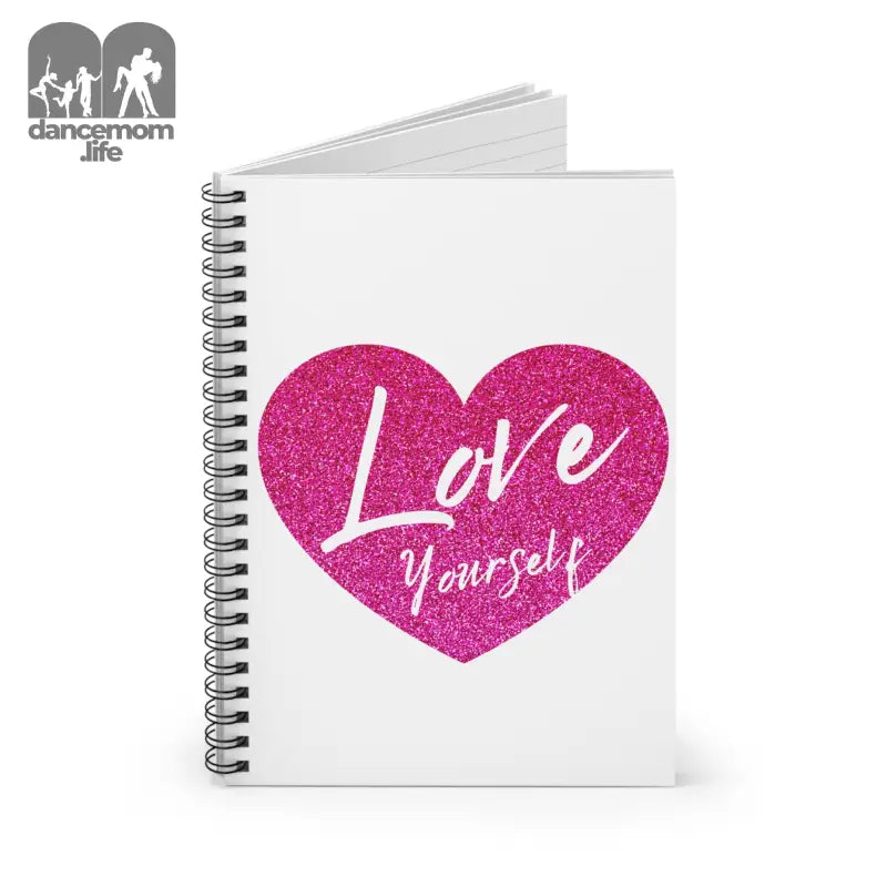 Spiral notebook with a pink glittery heart and ’Love Yourself’ text on the white cover.