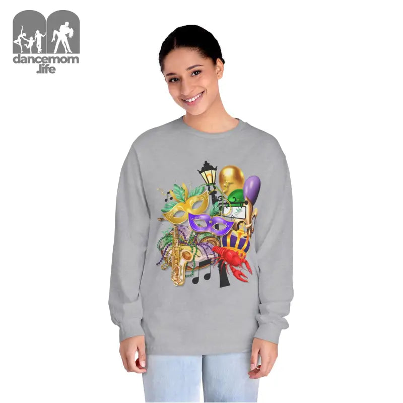 Grey sweatshirt featuring colorful Mardi Gras themed artwork with masks, musical notes, and party decorations.