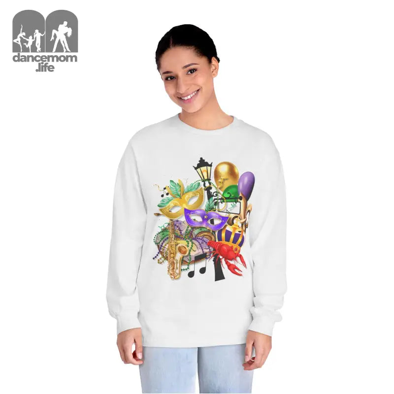 White sweatshirt featuring colorful Mardi Gras themed artwork with masks, musical notes, and festive decorations.