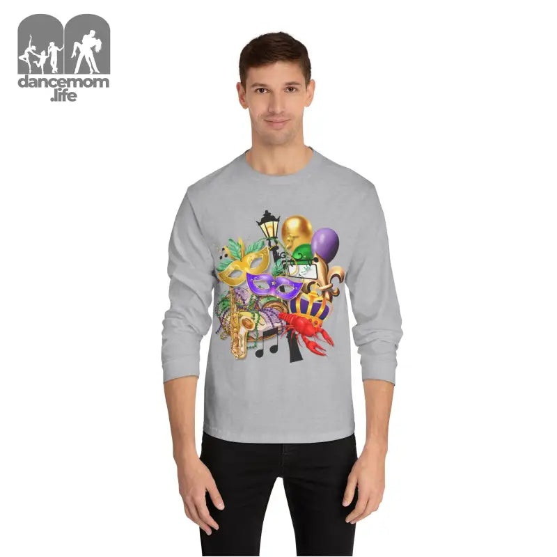 Light gray long-sleeve t-shirt with colorful Mardi Gras themed artwork featuring masks, balloons, and musical notes.