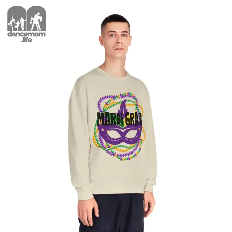 Beige sweatshirt featuring a colorful Mardi Gras carnival mask design with purple and green accents.