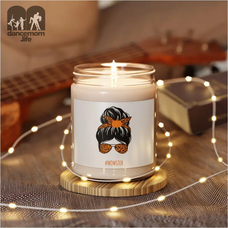 White jar candle with an illustration of a messy bun hairstyle and sunglasses on the front.