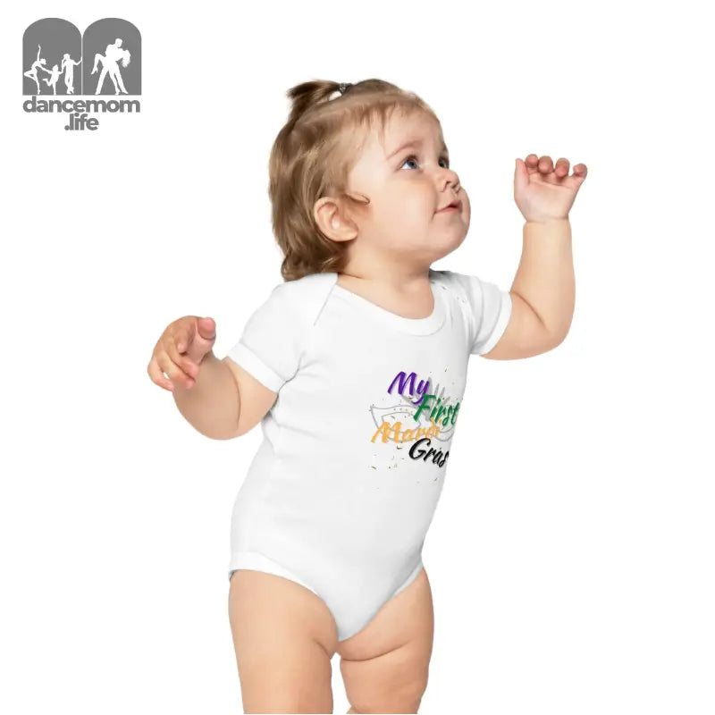 White baby onesie with colorful text design on the front.