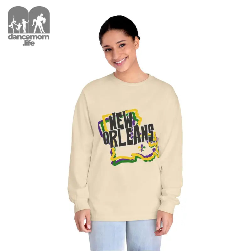 Beige sweatshirt with colorful ’New Orleans’ text and fleur-de-lis design.