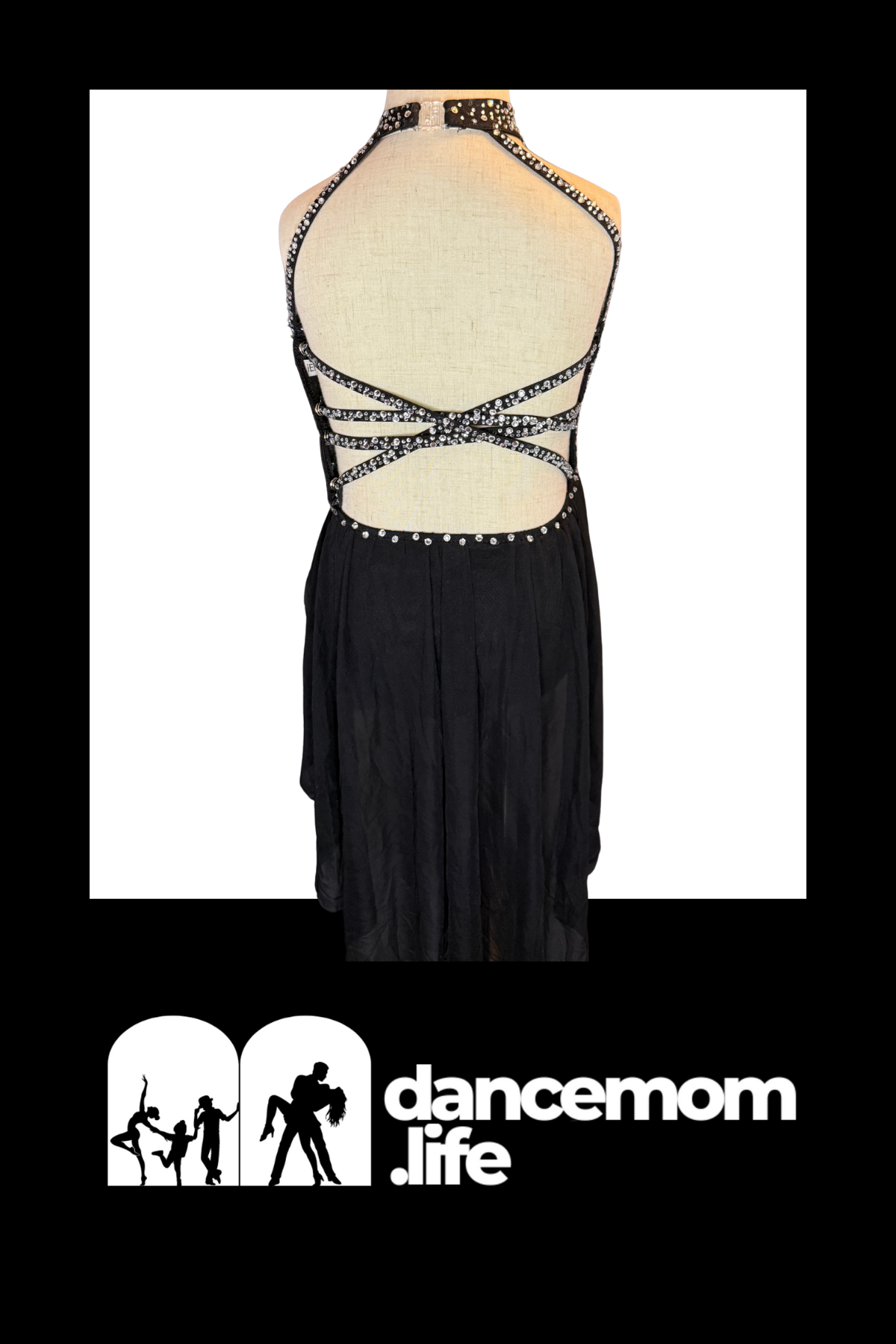 Black dance dress with a halter neckline and intricate crisscross straps adorned with sparkling rhinestones.