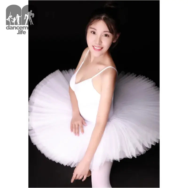 A ballerina wearing a white tutu and leotard.