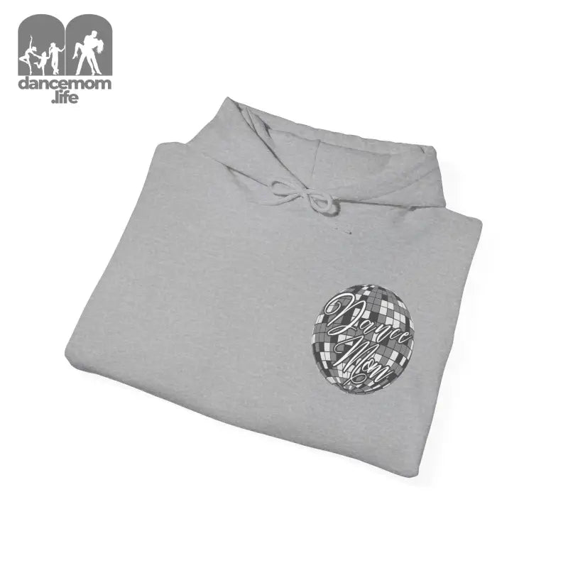 Light gray folded sweatshirt with a circular metallic logo design.