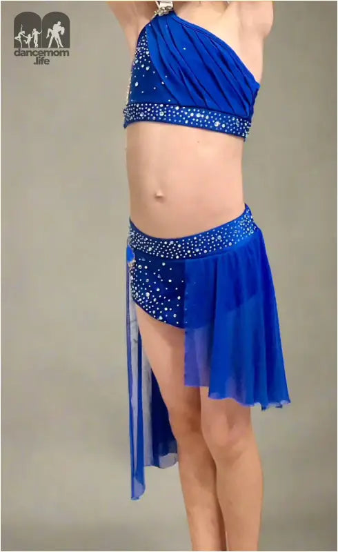 Bright blue two-piece dance costume with sparkly embellishments and asymmetrical skirt.