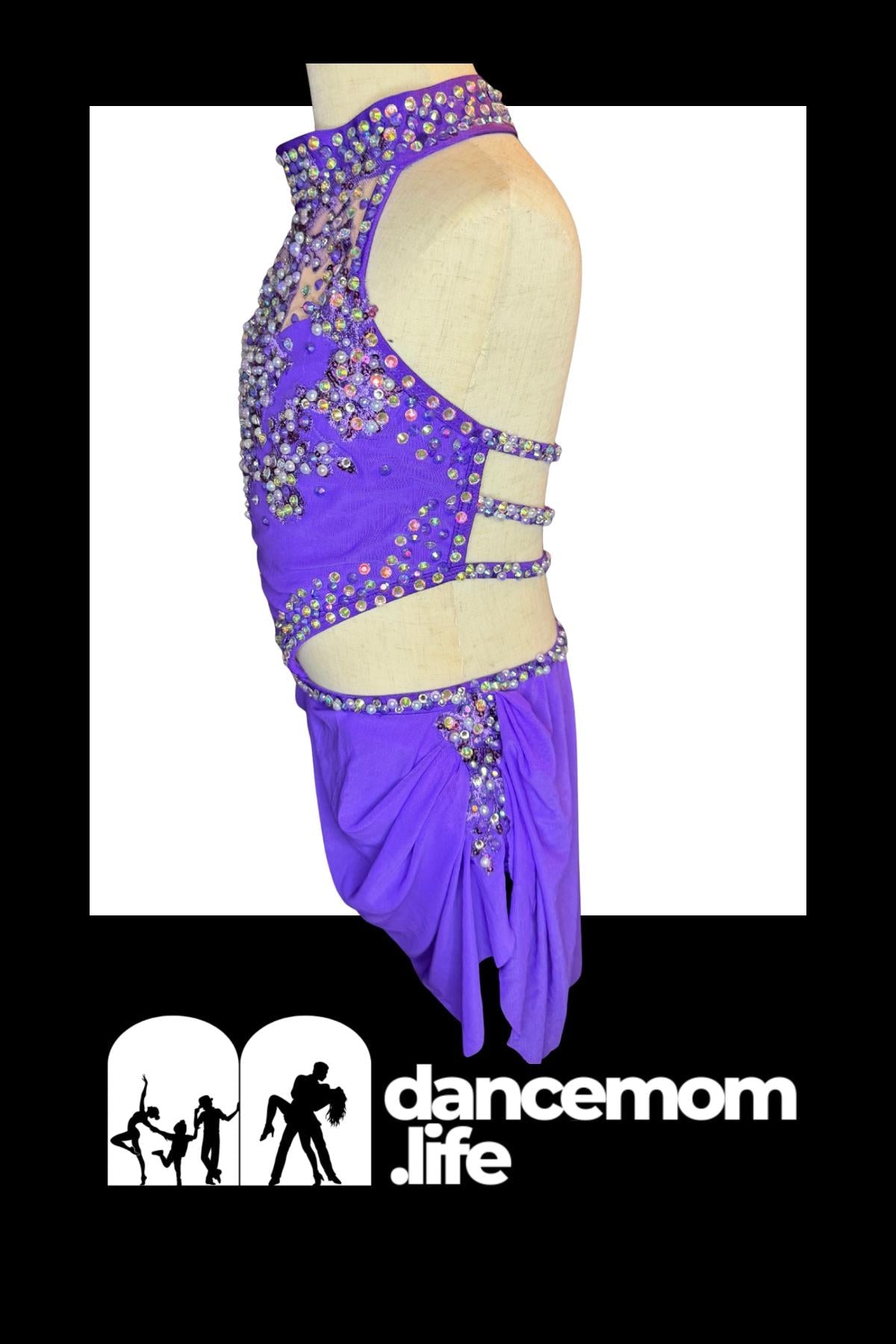 Vibrant purple dance leotard with sparkling rhinestone embellishments and a flowing skirt.