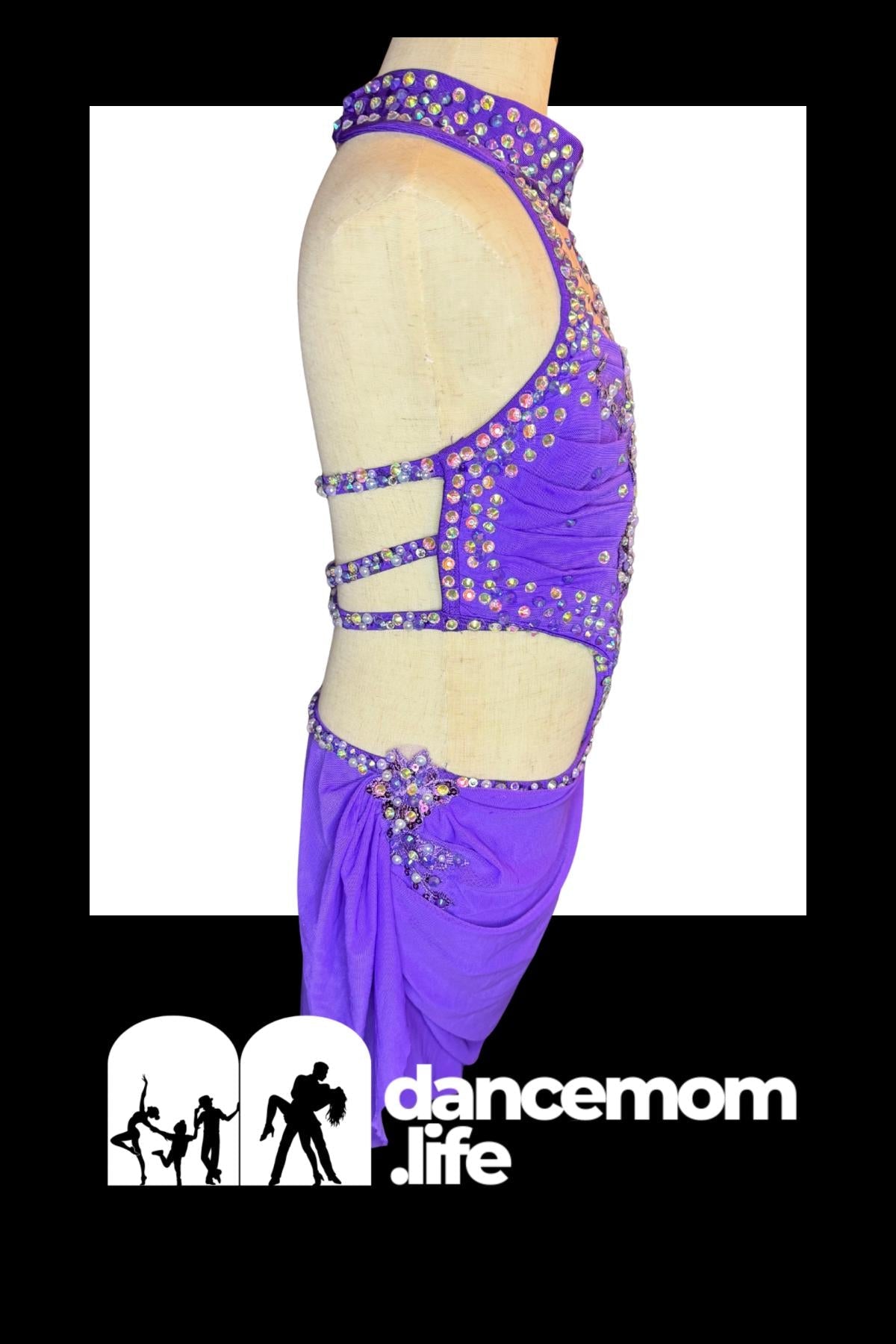 Purple sequined dance leotard with cut-out straps and a decorative bow at the waist.