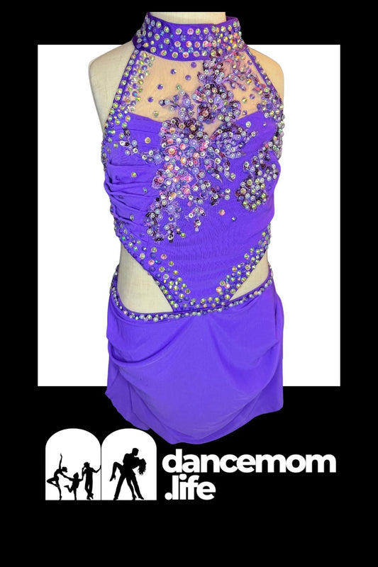 Vibrant purple dance leotard with a high neckline and intricate rhinestone embellishments forming floral patterns across the bodice.