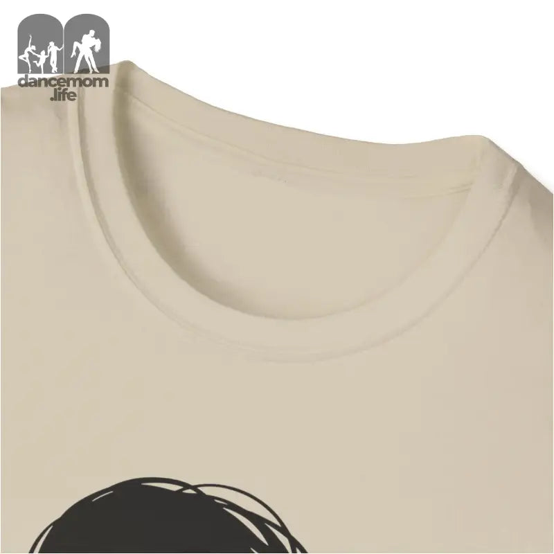 Beige or cream-colored t-shirt with a partial black graphic design visible.