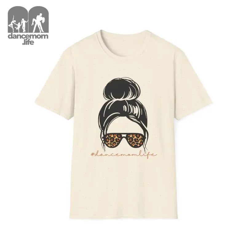 Cream-colored t-shirt featuring a messy bun hairstyle illustration with leopard print sunglasses.