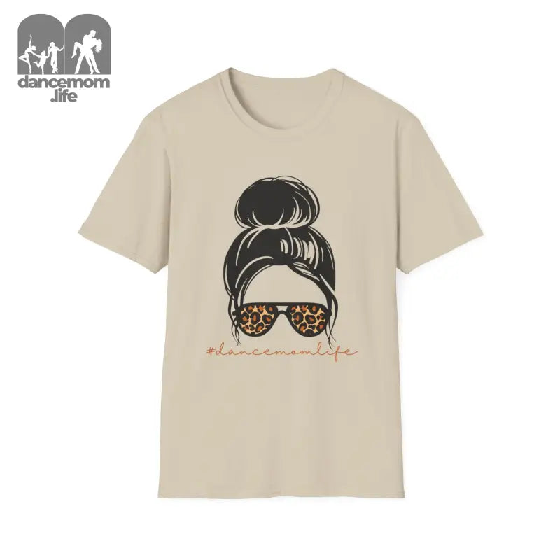 Beige t-shirt featuring a messy bun hairstyle illustration with leopard print sunglasses.