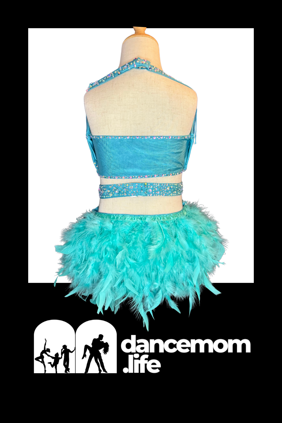 A vibrant turquoise feathered dance outfit with a beaded halter top and matching belt.